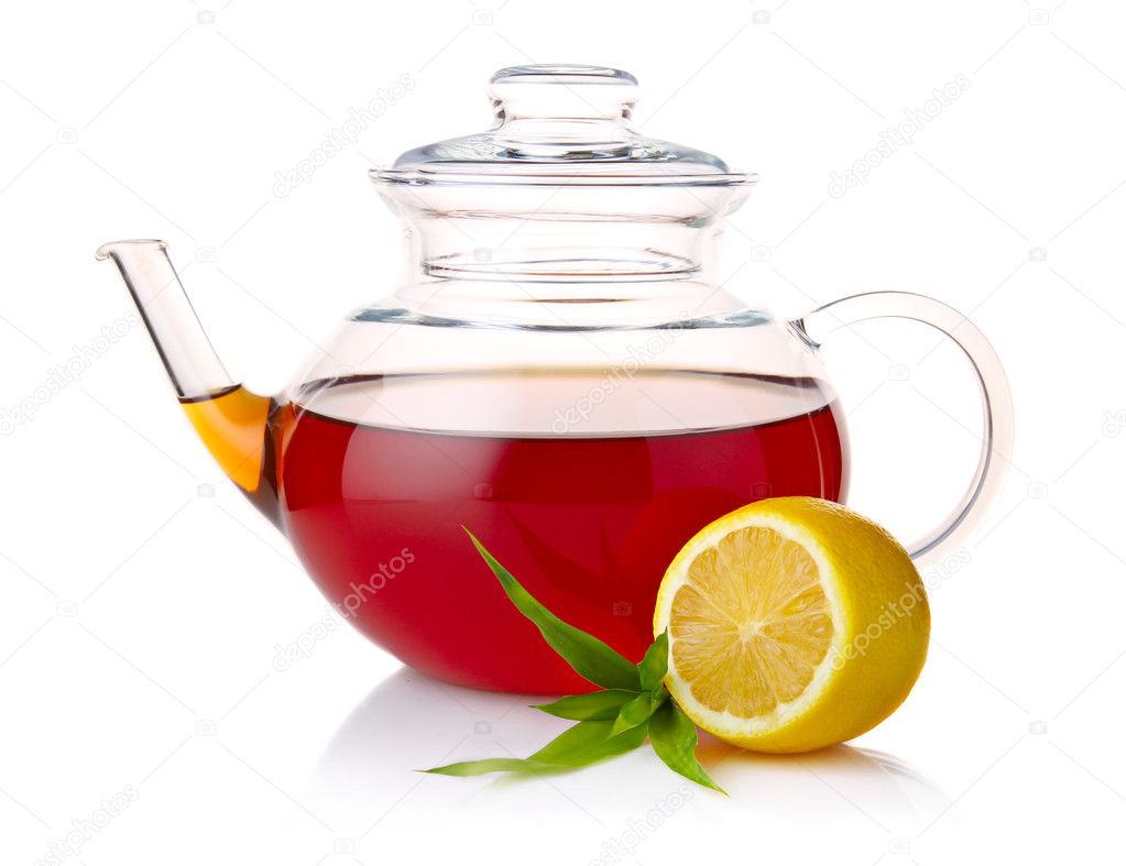 Teapot with black tea, green leaves and lemon slices isolated on
