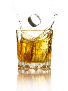 Splash in glass of whiskey and ice isolated clipart