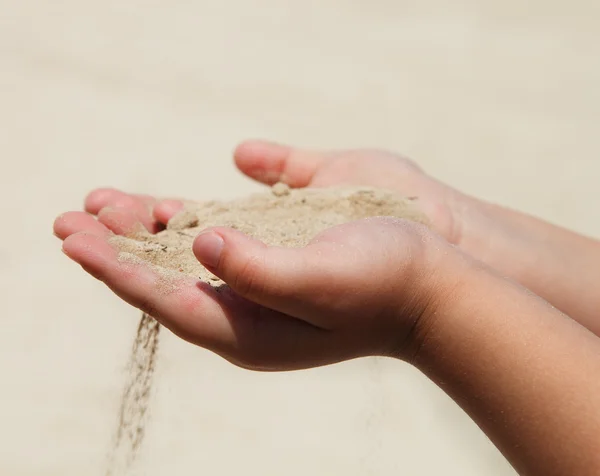 stock image Hands of the child holding sand