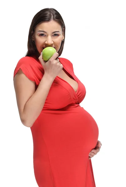 Счастливая беременная женщина с яблоком — стоковое фото