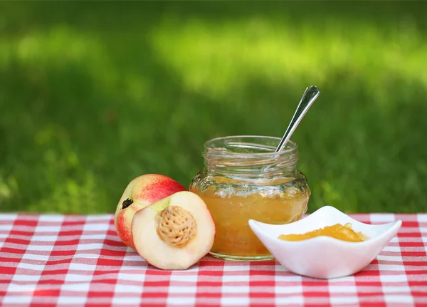 Jar of peach jam — Stock Photo, Image