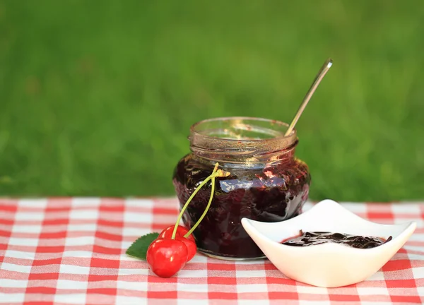 Jar of sweet cherry jam — Stock Photo, Image