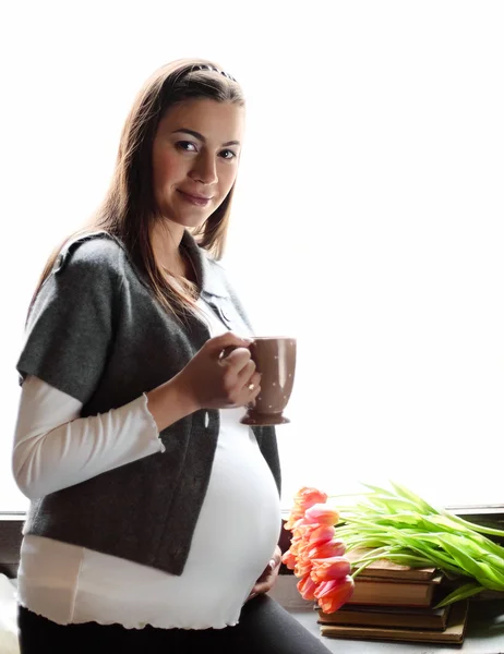 Felice donna incinta sorridente bere il tè — Foto Stock