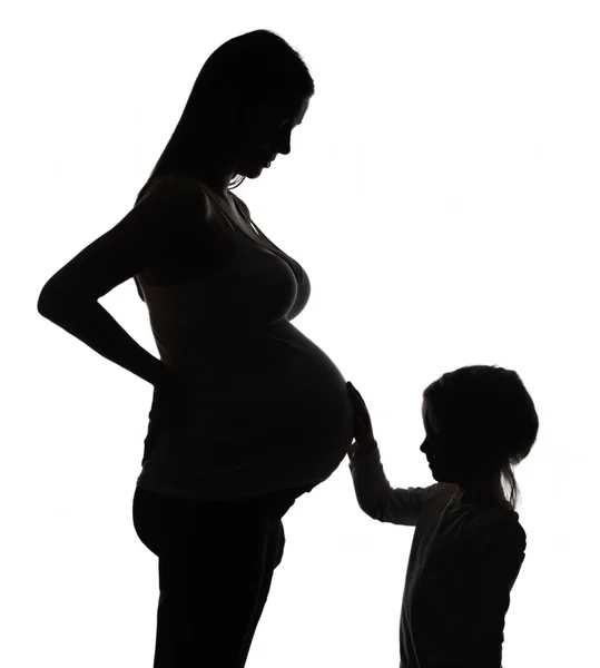 Silhouette della donna incinta con figlia — Foto Stock