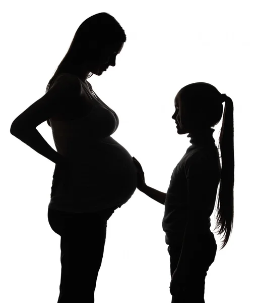 La silueta de la mujer embarazada con la hija — Foto de Stock