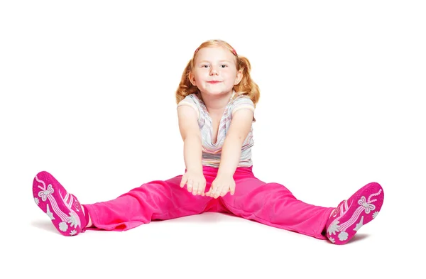 Little girl stretching studio isolated on white background — Stock Photo, Image