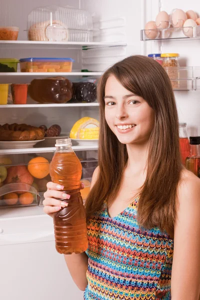 Beautiful girl on background refrigerator — Stock Photo, Image