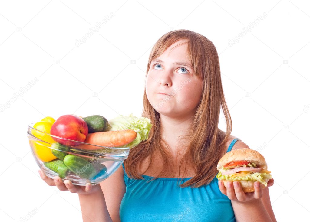 Girl with vegetables and hamburger