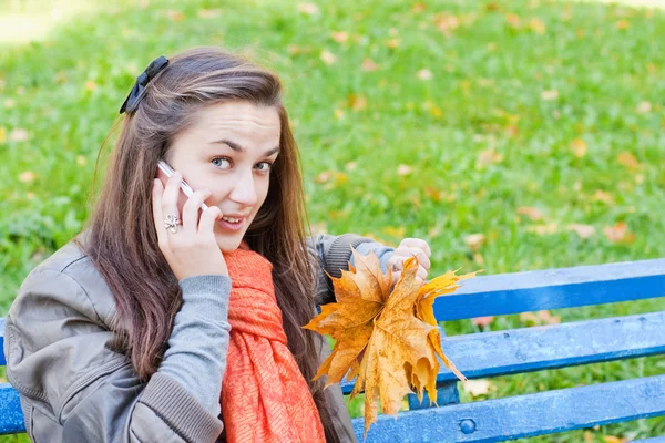 stock image Girl with phone in autumn park