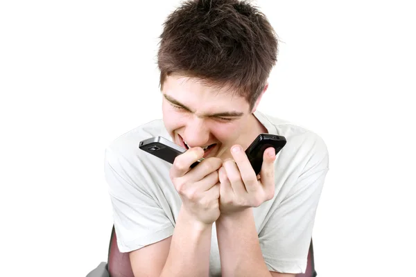 Злой подросток с двумя телефонами — стоковое фото