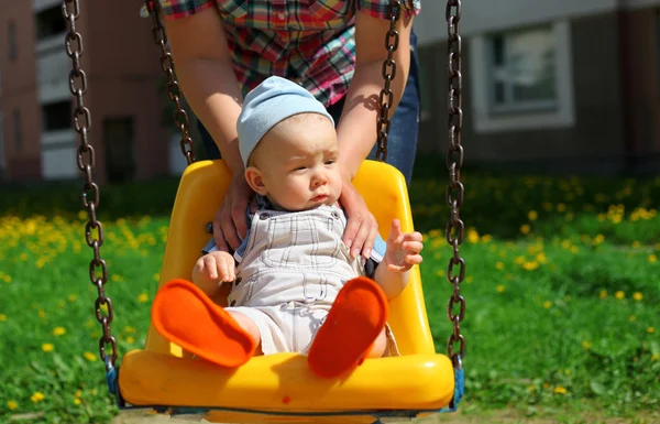 Mother with a little boy on a swing — Stock Photo, Image