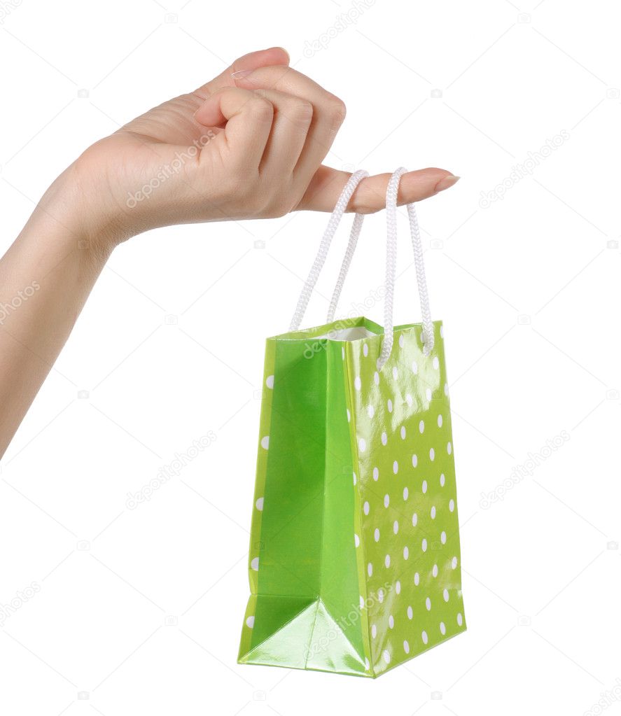 Bright gift bags in hand isolated on white