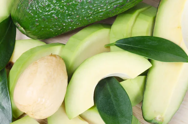 stock image Cut fresh avocado with leaves