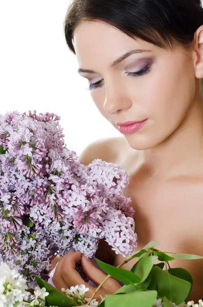 Bella donna con fiori primaverili di un lilla. Cura della pelle — Foto Stock