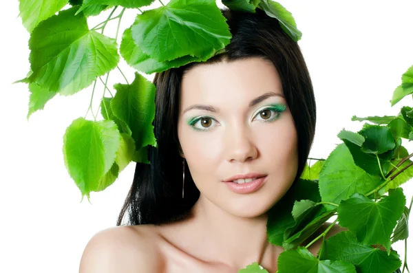 Beautiful woman with spring green leaves Royalty Free Stock Photos