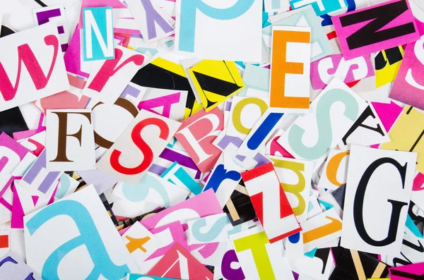 The letters which have been cut out from newspapers close up — Stock Photo, Image