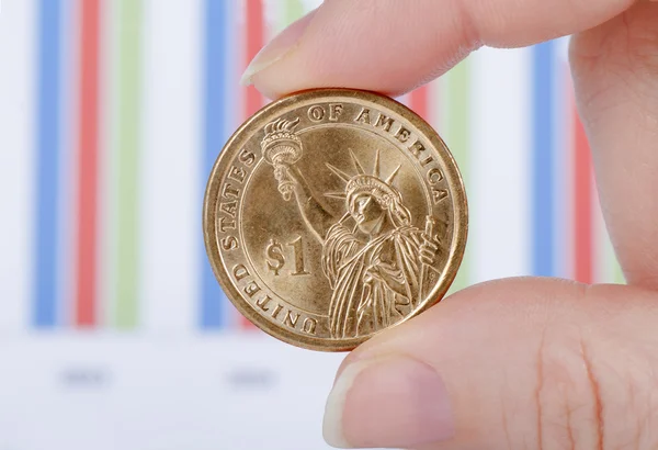 stock image Coins in a hand against business of diagrammes