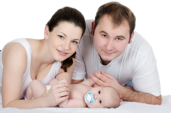 Porträtt av en ung lycklig familj med barnet Stockfoto