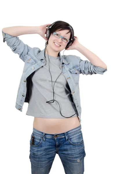 Menina ouve música através de fones de ouvido — Fotografia de Stock