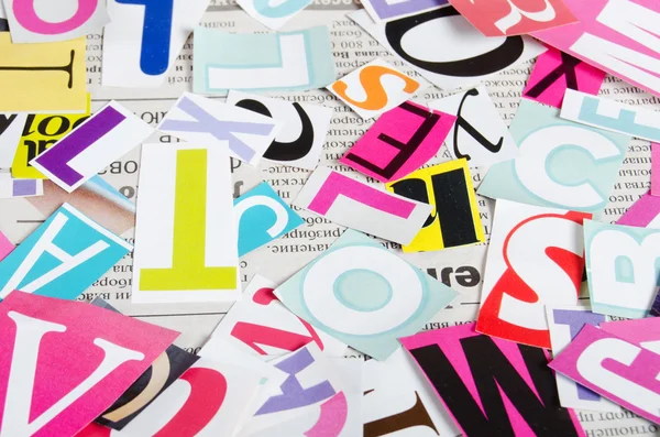 The letters which have been cut out from newspapers close up — Stock Photo, Image