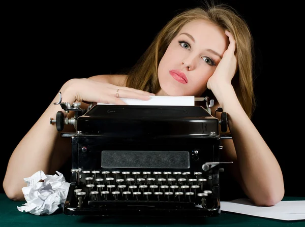 The beautiful girl at a typewriter. A retro style — Stock Photo, Image