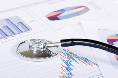 Stethoscope on a stock chart - market analysis clipart