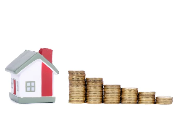 Toy small house and coins in the form of the diagram. concept — Stock Photo, Image