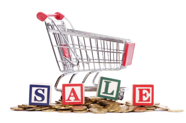 Coins, shopping cart and word SALE — Stock Photo, Image