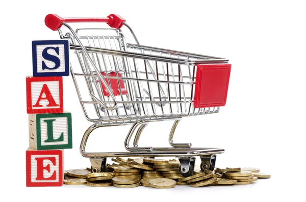 Shopping cart and coins — Stock Photo, Image