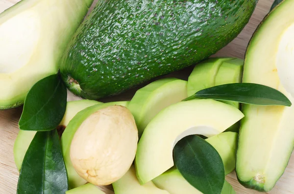 stock image Cut fresh avocado with leaves