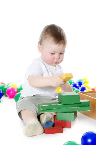 The little boy plays multi-coloured toys