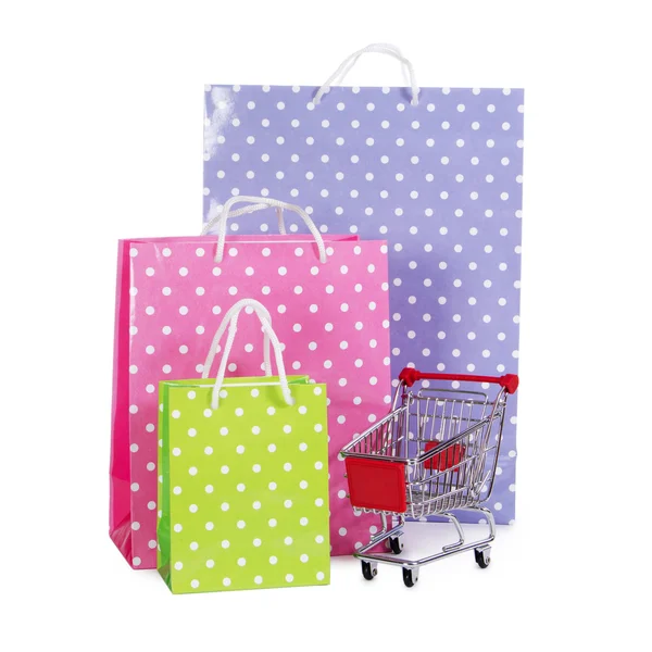 Nákupní vozík a tašky izolovaných na bílém — Stock fotografie