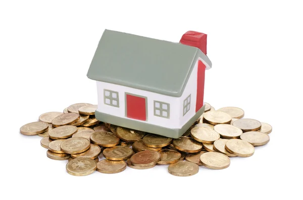 Toy small house and coins — Stock Photo, Image