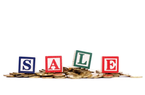 Coins in form of the diagramme and word SALE — Stock Photo, Image