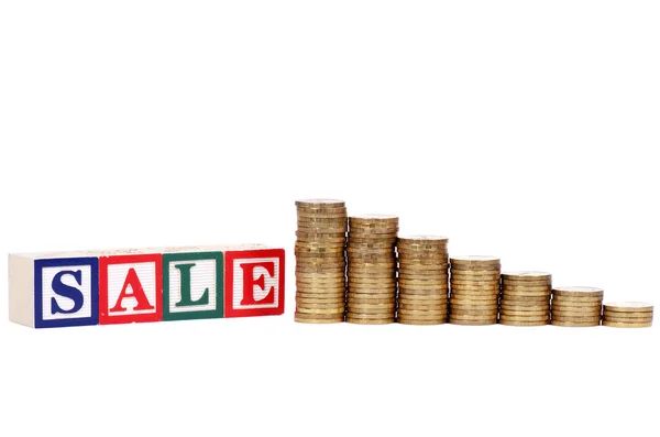 Coins in form of the diagramme and word SALE — Stock Photo, Image