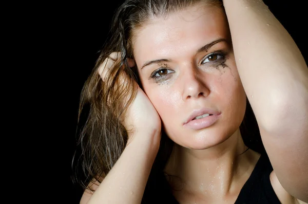 The wet girl with the spread cosmetics on the black — Stock Photo, Image