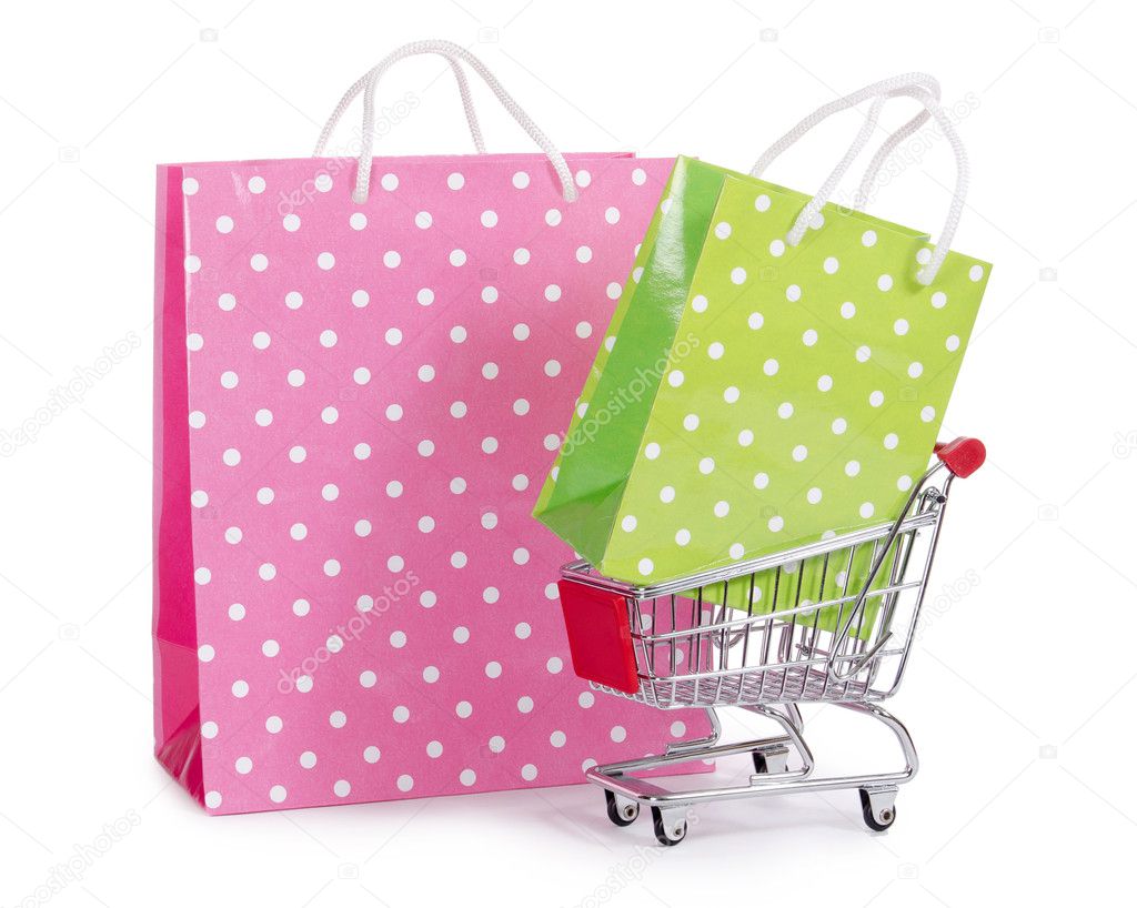 The shopping cart and bags isolated on white