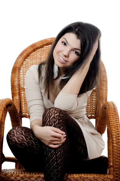 The beautiful girl in wicker chair — Stock Photo, Image