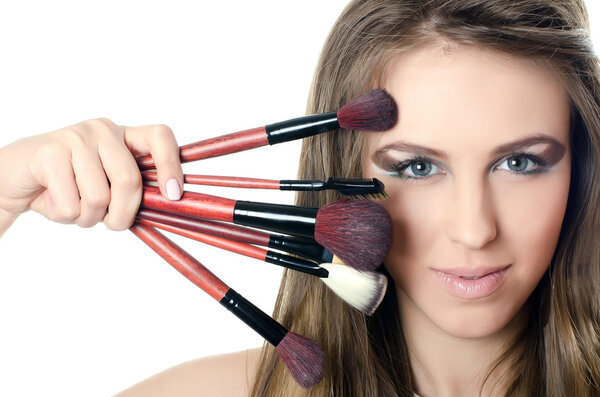 The beautiful girl with brushes for a make-up