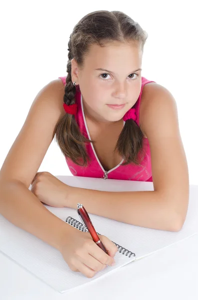 The young girl writes to writing-books — Stock Photo, Image