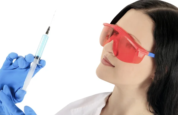 Female doctor wearing a protective glasses with syringe — Stock Photo, Image