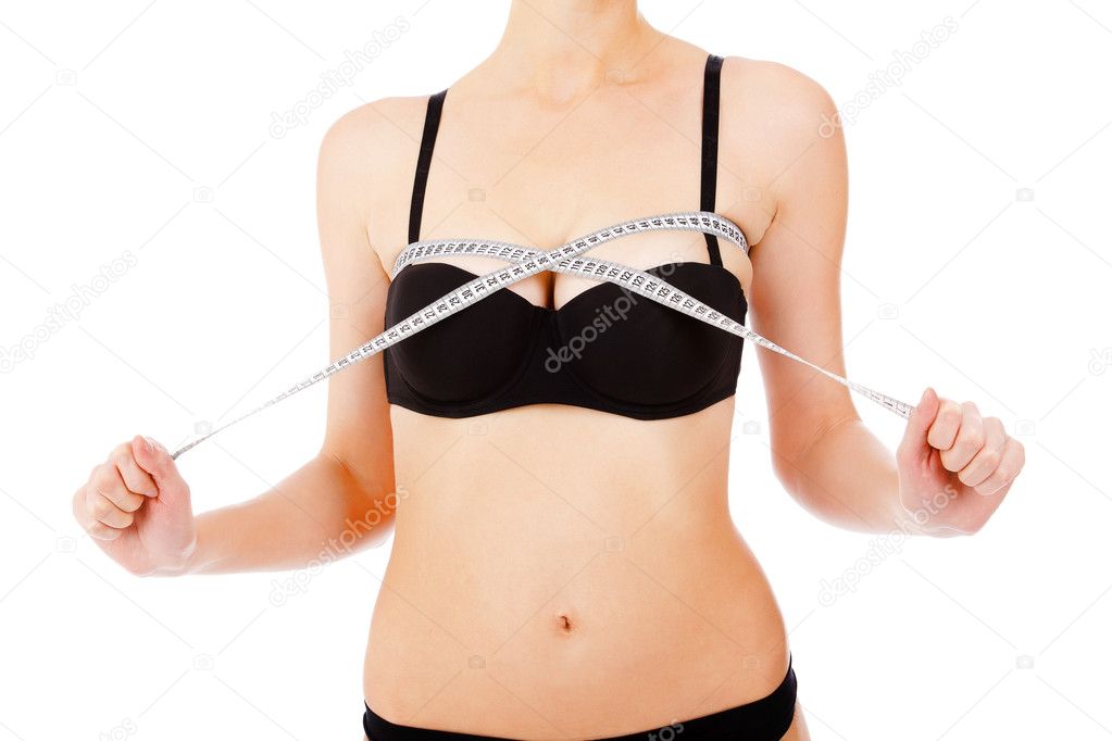 Woman measures breast by measurement tape