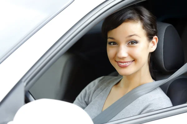 Cute asian female driver in white car smiling to you. — Stock Photo, Image