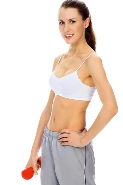 Mujer joven bastante feliz haciendo ejercicio con pesas libres —  Fotos de Stock