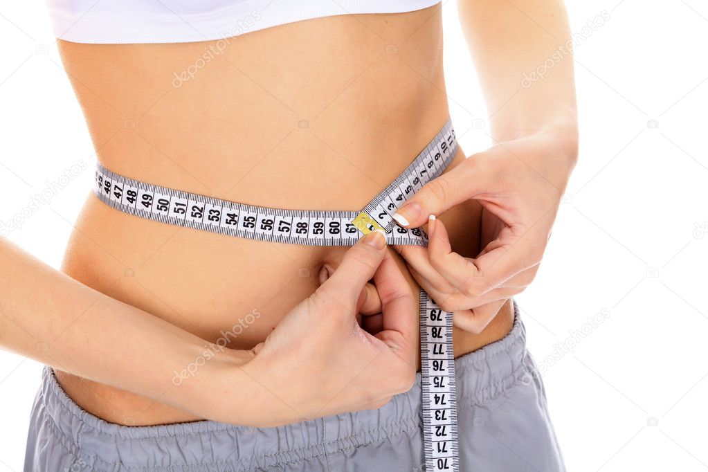 Cropped image of a fit young woman measuring her waistline — Stock Photo, Image