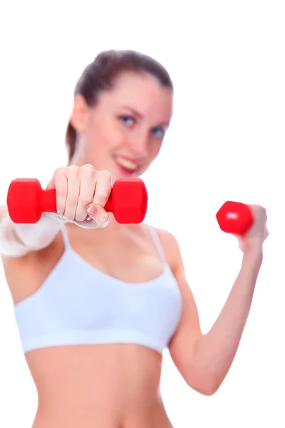 Smiling woman with barbells, focus is on the nearest barbell — Stock Photo, Image
