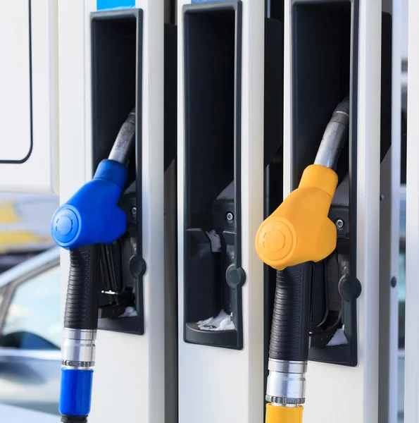 Gas pump nozzles in a service station — Stock Photo, Image