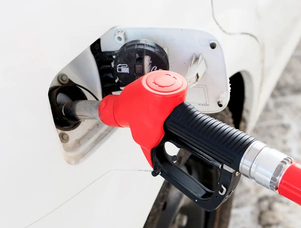 White car at gas station being filled with fuel — Stock Photo, Image