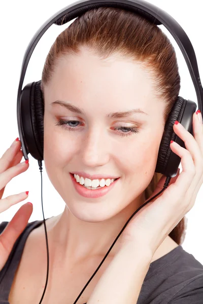 Mooi meisje muziek luistert en lacht om u — Stockfoto