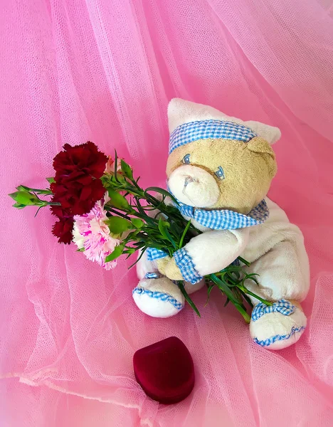 Sad love teddy bear with flowers and gifts. — Stock Photo, Image